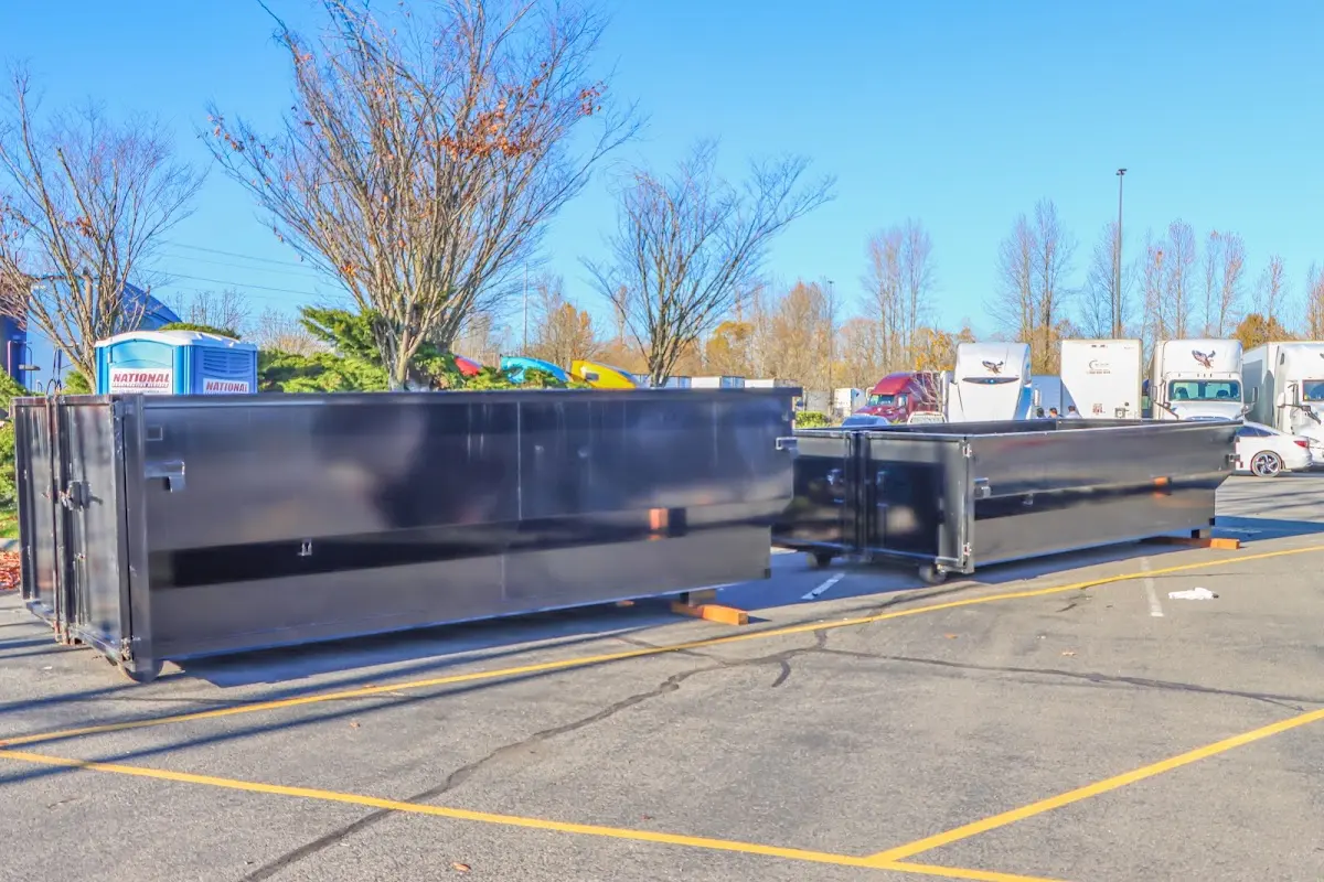 Professional dumpster rental service with roll-off container on residential driveway in Lenox